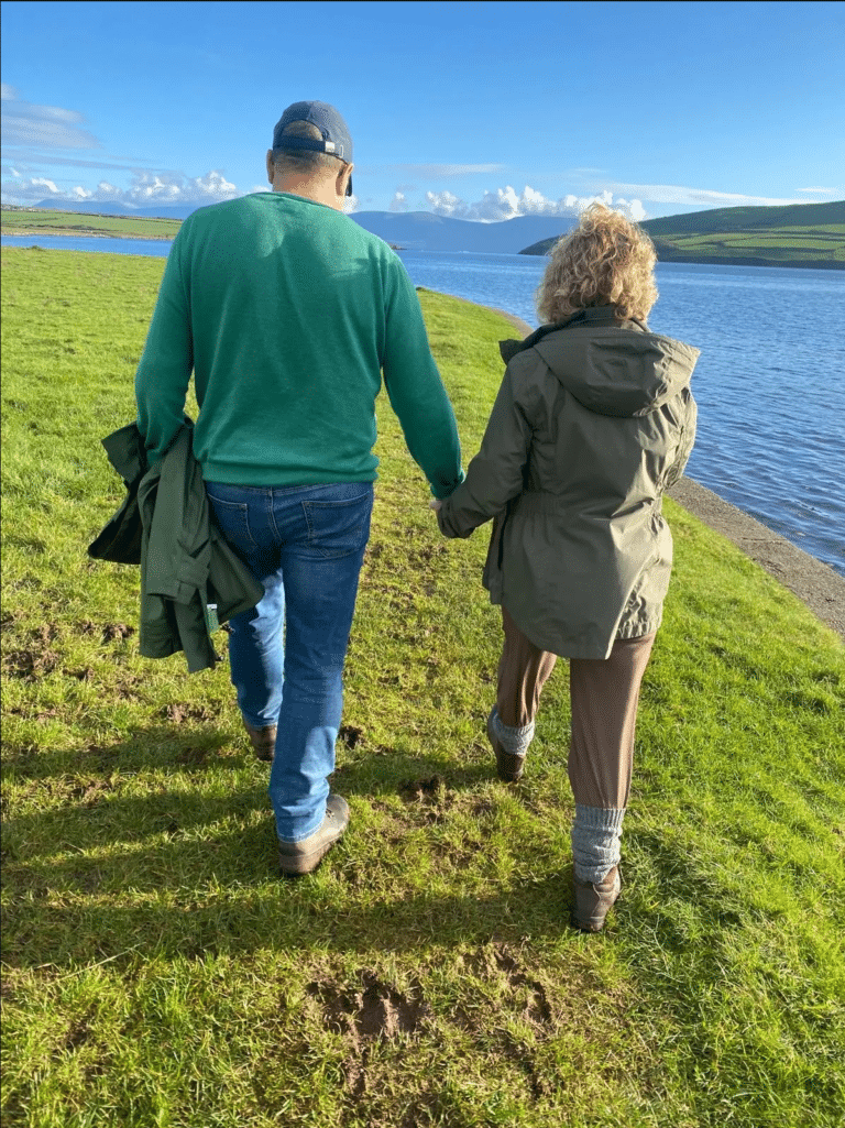 Reviews 1 Couple walking hand in hand beside the water, photo shared by a client with her review